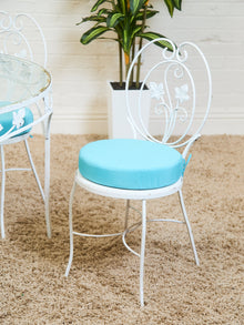 Vintage Wrought Iron Patio Dining Table with Leaf Motif Aqua Cushions and Glass Top