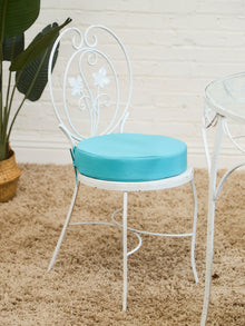 Vintage Wrought Iron Patio Dining Table with Leaf Motif Aqua Cushions and Glass Top