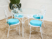 Vintage Wrought Iron Patio Dining Table with Leaf Motif Aqua Cushions and Glass Top
