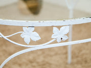 Vintage Wrought Iron Patio Dining Table with Leaf Motif Aqua Cushions and Glass Top