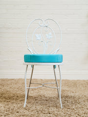 Vintage Wrought Iron Patio Dining Table with Leaf Motif Aqua Cushions and Glass Top