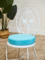 Vintage Wrought Iron Patio Dining Table with Leaf Motif Aqua Cushions and Glass Top