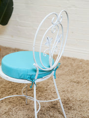 Vintage Wrought Iron Patio Dining Table with Leaf Motif Aqua Cushions and Glass Top