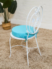 Vintage Wrought Iron Patio Dining Table with Leaf Motif Aqua Cushions and Glass Top