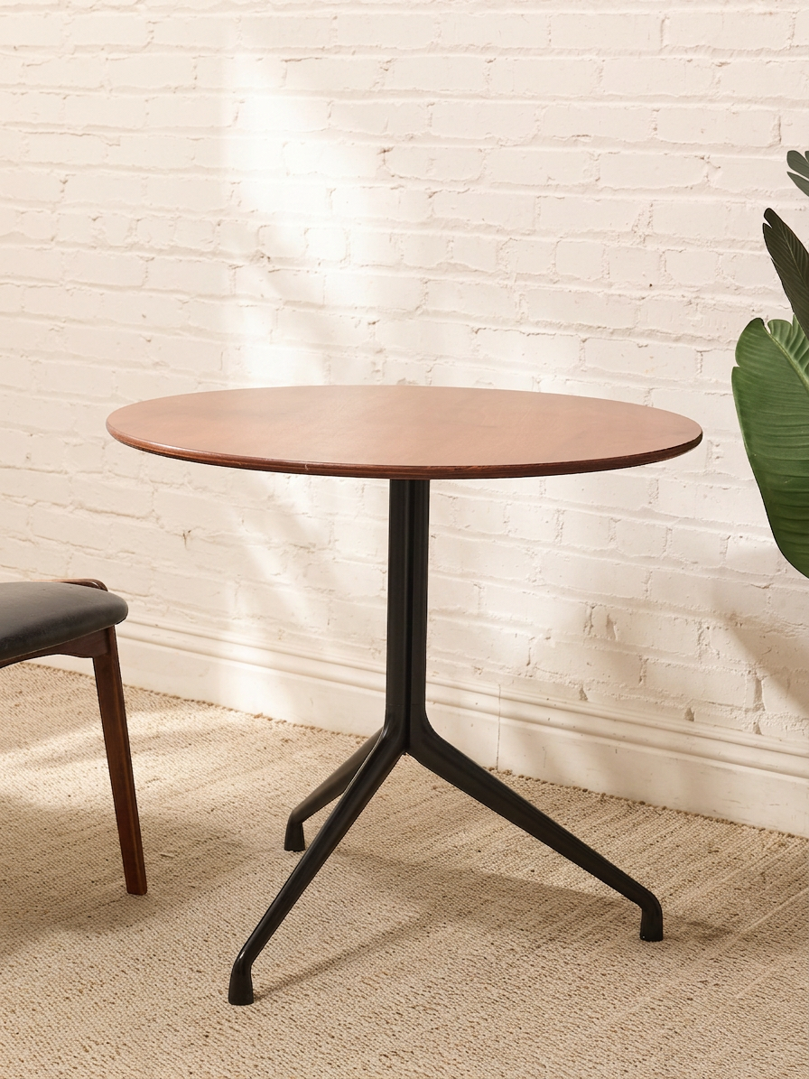 Round Walnut-Tone Pedestal Dining Table with Black Metal Base