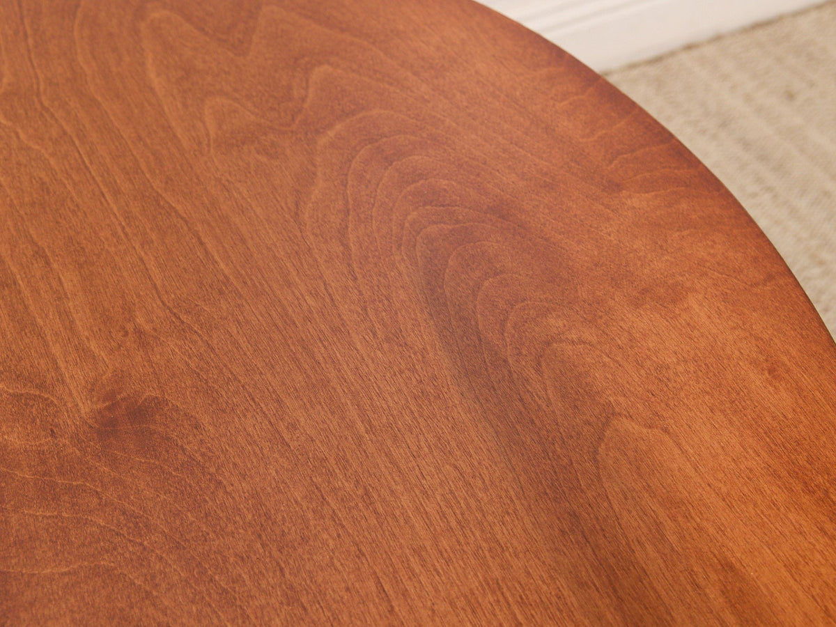 Round Walnut-Tone Pedestal Dining Table with Black Metal Base