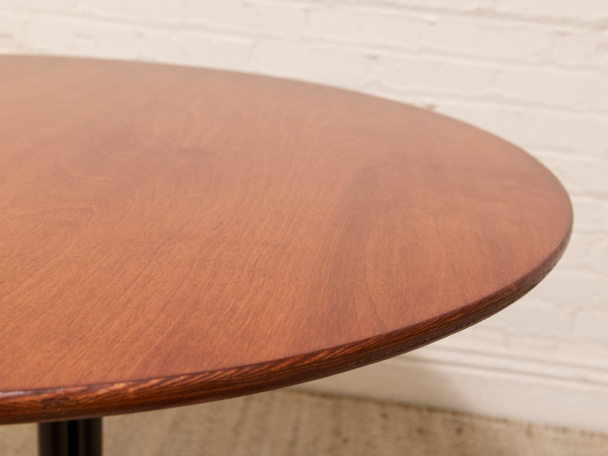Round Walnut-Tone Pedestal Dining Table with Black Metal Base